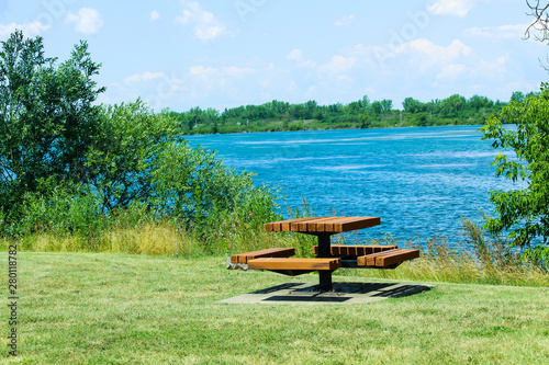 Picnic table on the grass by the lake