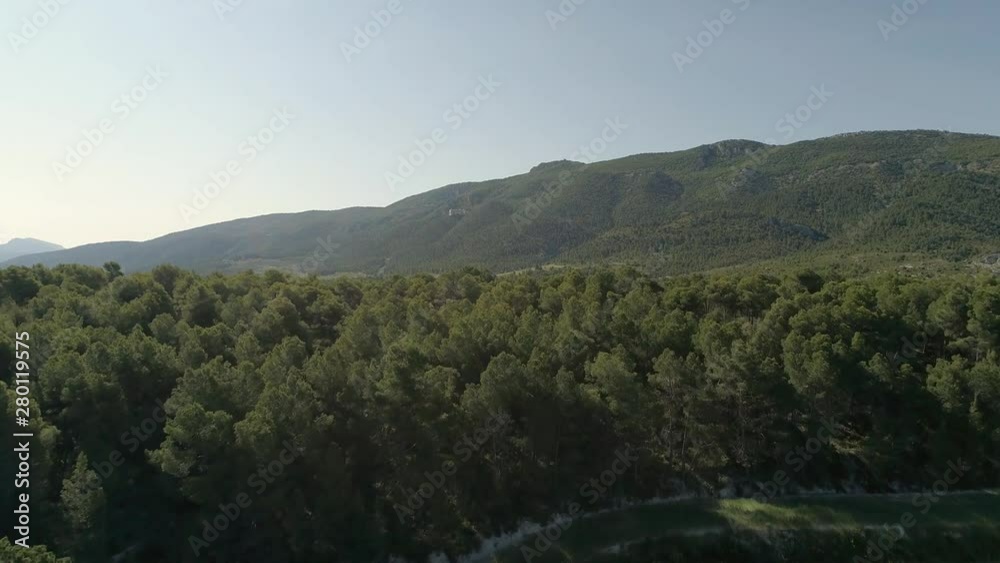 zoom in from drone travel through the nature of alcoy with views of mountains covered with pine forests and fields zoom in from drone travel through the nature of alcoy with views of mountains covered with pine forests and fields