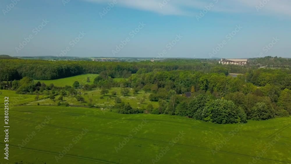 Aerial view of crop field blowing in the wind with forest in the background in a rural area Aerial view of crop field blowing in the wind with forest in the background in a rural area