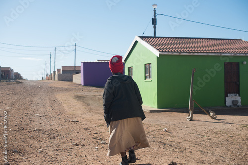 Obraz na plátně Woman walking in township in South Africa