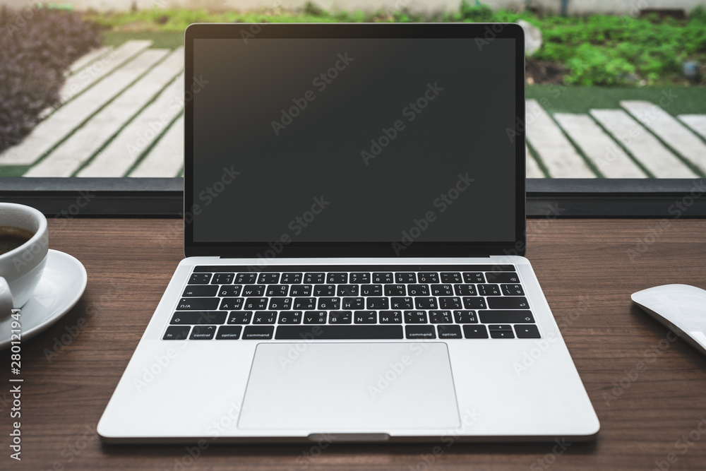 Empty white screen laptop computer on wooden table top, business concept. Mockup design with copy space. Empty white screen laptop computer on wooden table top, business concept. Mockup design with copy space.