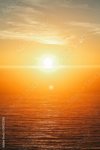Fototapeta Naklejka Na Ścianę i Meble -  Vertical shot of a beautiful sea at sunset at Big Sur, California, USA