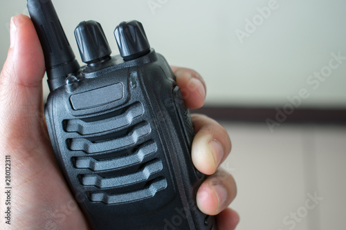Hand holding radio communication, close up. photo