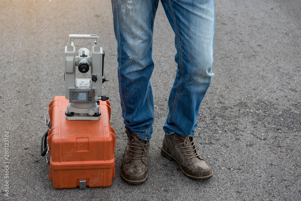 Civil engineer with Surveyor equipment tacheometer or theodolite outdoors at construction site on the road. Civil engineer with Surveyor equipment tacheometer or theodolite outdoors at construction site on the road.