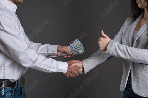 Close up photo of man hands giving money to a woman. Succesfull deal between partners. ..money laundering. illegal cash transactions photo