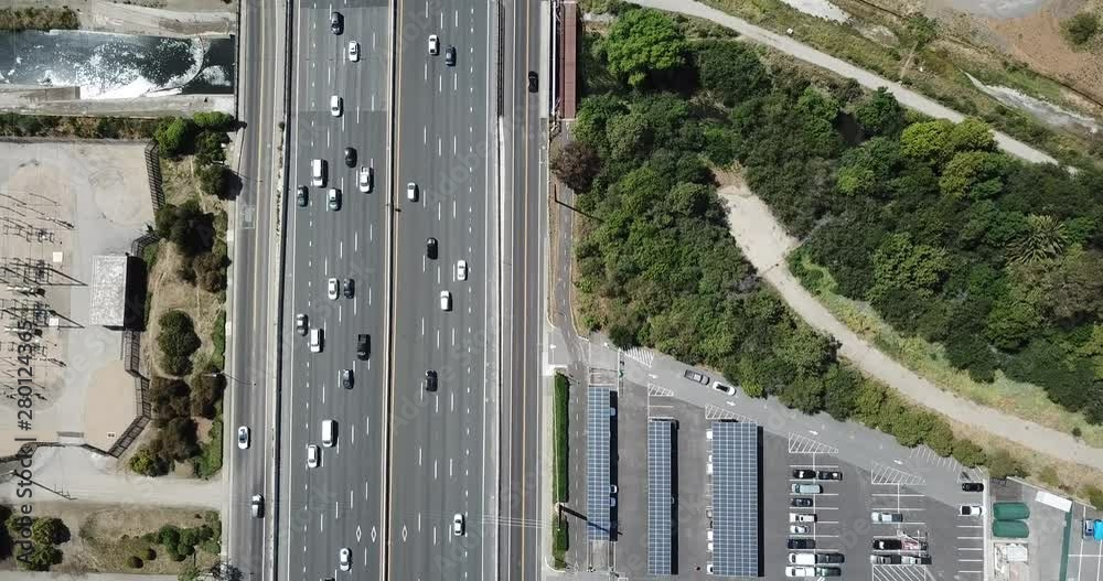 Top down pan up view of highway traffic on 101 roof top solar panels pan handle garden zoom in Top down pan up view of highway traffic on 101 roof top solar panels pan handle garden zoom in