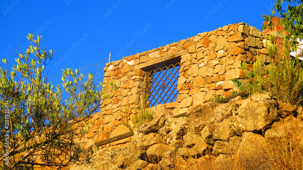 Granite block wall with iron barred window