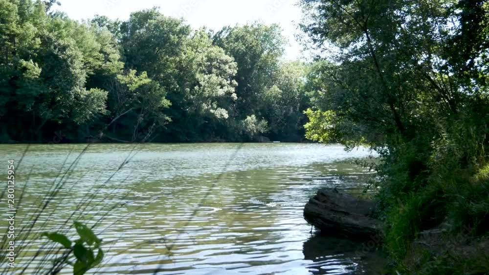 The river surrounded by green trees .Ariège River during the summer season surrounded by green trees.