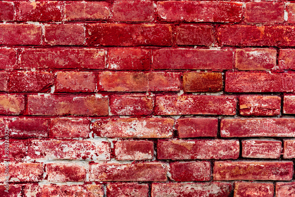 Texture of a brick wall with cracks and scratches which can be used as a background Texture of a brick wall with cracks and scratches which can be used as a background