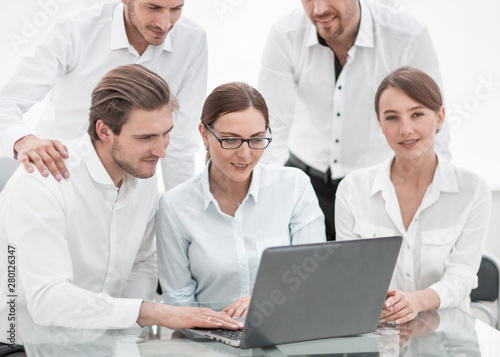 business team uses a laptop to work on a new project.