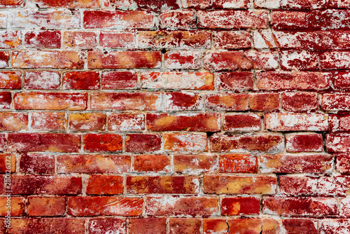 Texture of a brick wall with cracks and scratches which can be used as a background