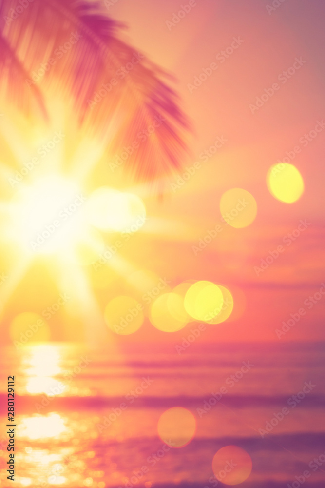 Blur beautiful nature green palm leaf on tropical beach with bokeh sun light wave abstract background.