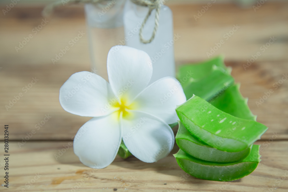 Aloe vera Fresh stacked with drop water and aloe vera juice in glass bowl with honey in jar on old wood Aloe vera Fresh stacked with drop water and aloe vera juice in glass bowl with honey in jar on old wood