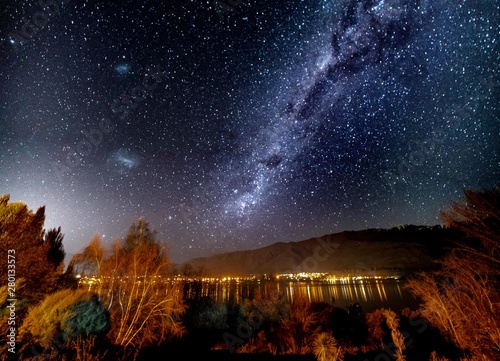 under the milky way and stars on the shore of :Lake Wanaka