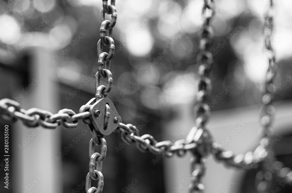 Rows of shining metal chains with beautiful bokeh stylized black and white film Rows of shining metal chains with beautiful bokeh stylized black and white film