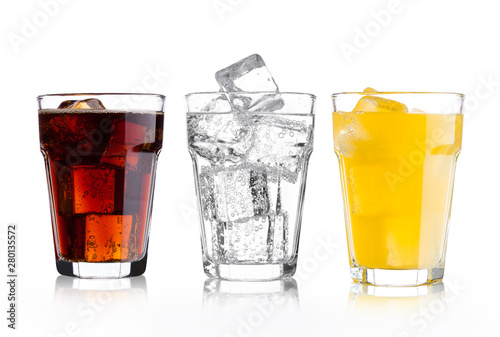 Glasses of cola and orange soda drink and lemonade photo