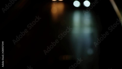 Blurred bokeh of moving transport. Defocused traffic lights at night.