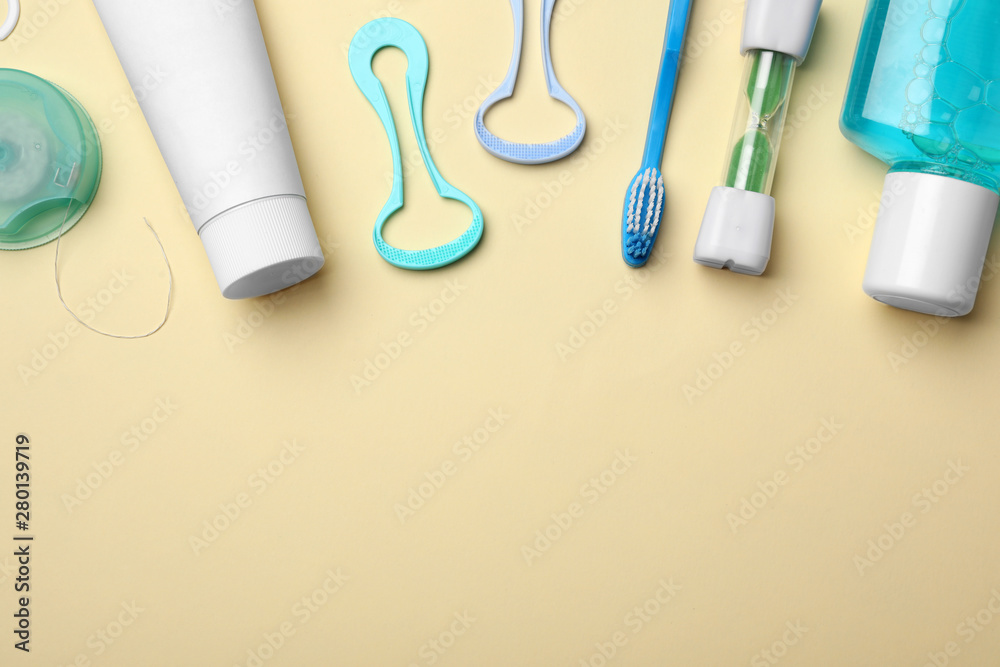 Flat lay composition with tongue cleaners and teeth care products on color background. Space for text