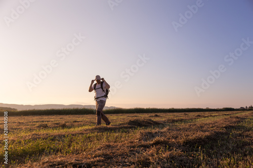 backpacker traveler walking at sunrise © robcartorres