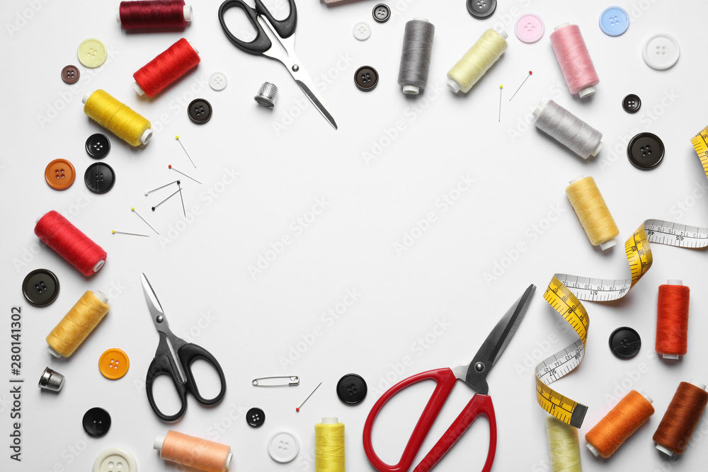 Frame made of scissors and other sewing accessories on white background, top view. Space for text Frame made of scissors and other sewing accessories on white background, top view. Space for text