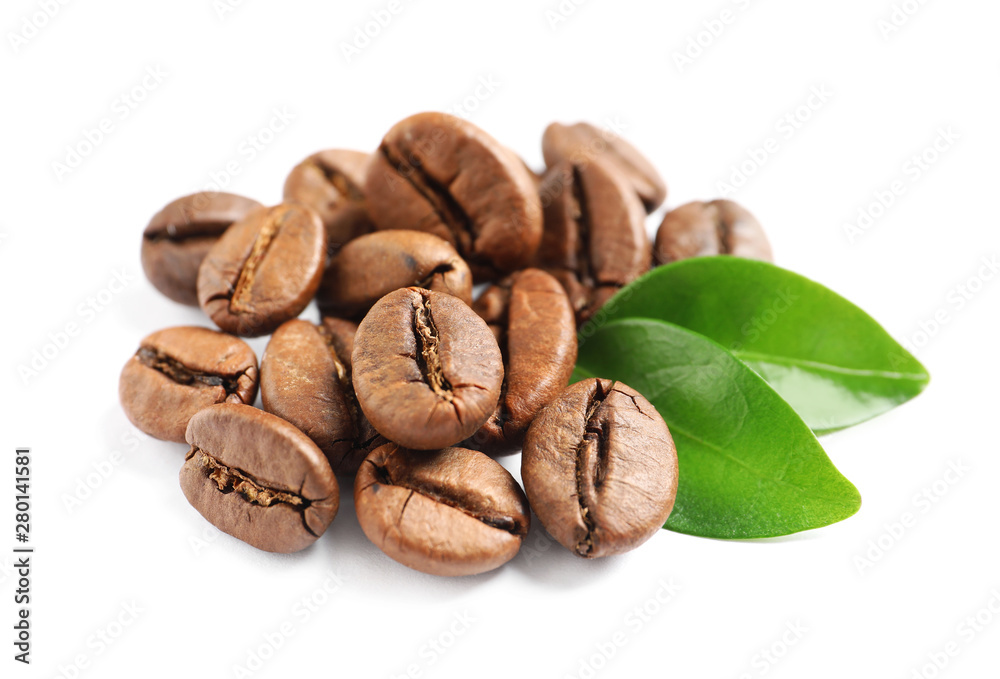 Fototapeta premium Roasted coffee beans and fresh green leaves on white background