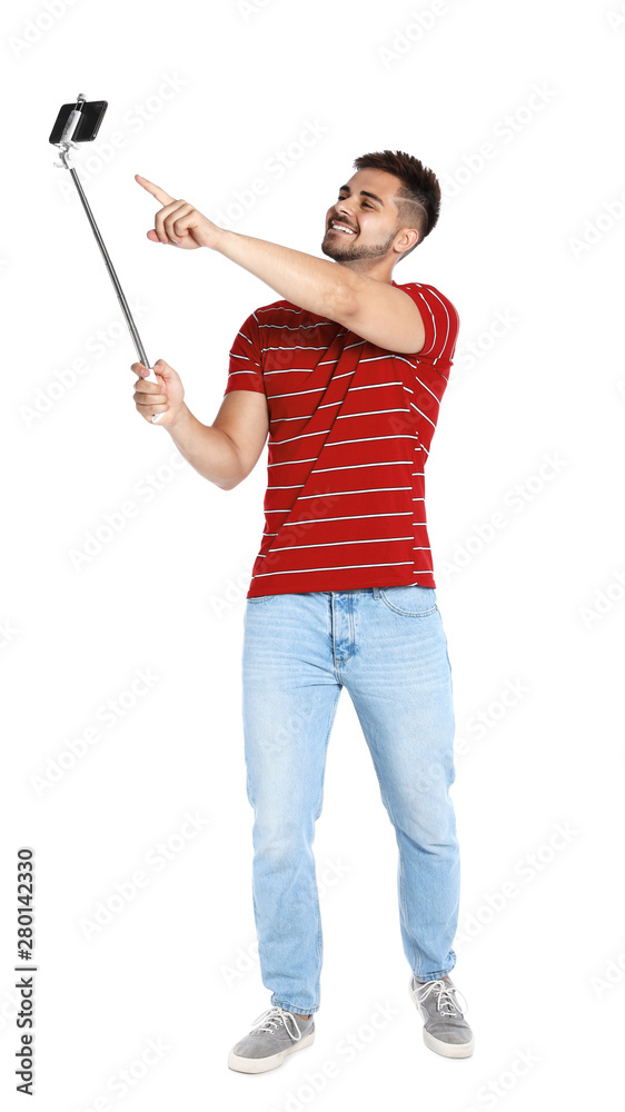 Happy young man taking selfie on white background Happy young man taking selfie on white background