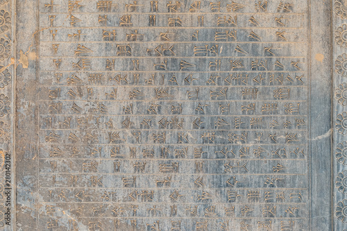 Ancien inscriptions on the walls of Persepolis, the ancient capital of old Persian Achaemenid Empire in Iran, Zoroastrian symbol Faravahar photo