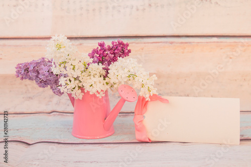 Lilac flowers bouquet in watering can