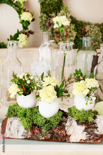 Easter decoration with egg shell, carnation flower, buxus, chamelaucium and moss © agneskantaruk