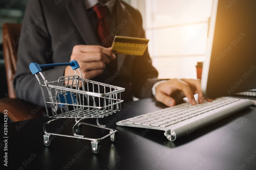 Business woman hands using smartphone and holding credit card with digital layer effect diagram as Online shopping concept Business woman hands using smartphone and holding credit card with digital layer effect diagram as Online shopping concept