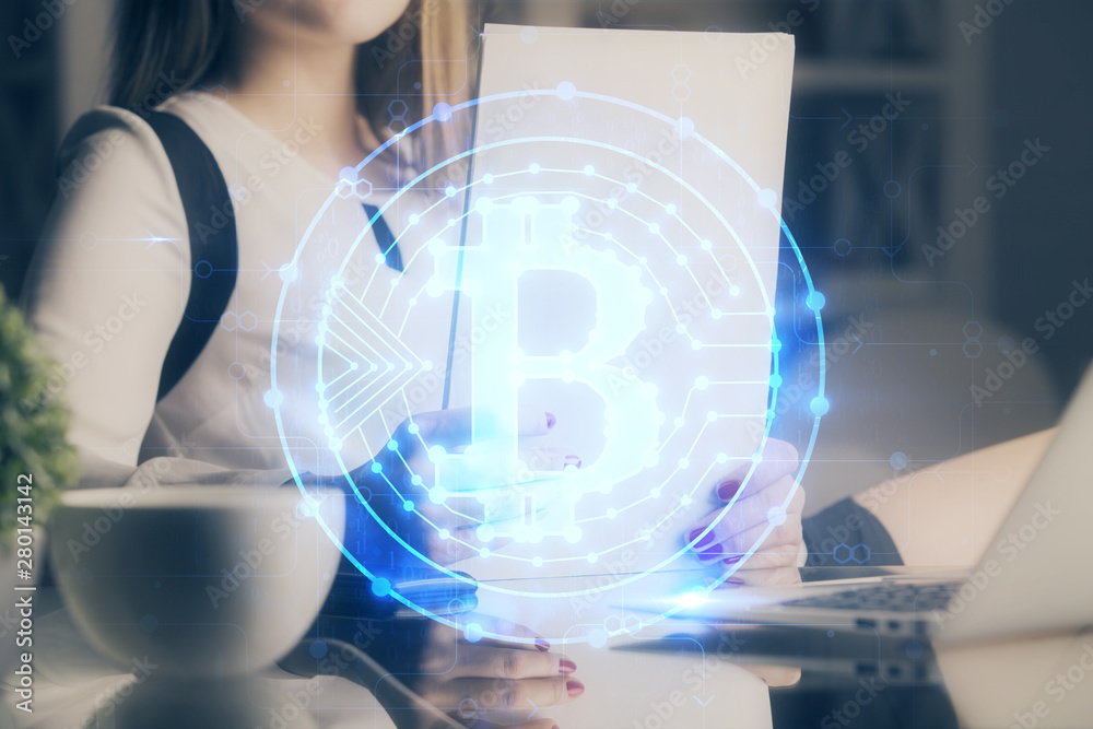 Cryptocurrency hologram over woman's hands writing background. Concept of blockchain. Double exposure Cryptocurrency hologram over woman's hands writing background. Concept of blockchain. Double exposure