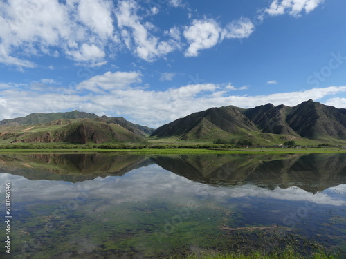 Fototapeta Naklejka Na Ścianę i Meble -  Beautiful landscape in western China Mountains clouds blue sky and mirroring christal clear lake