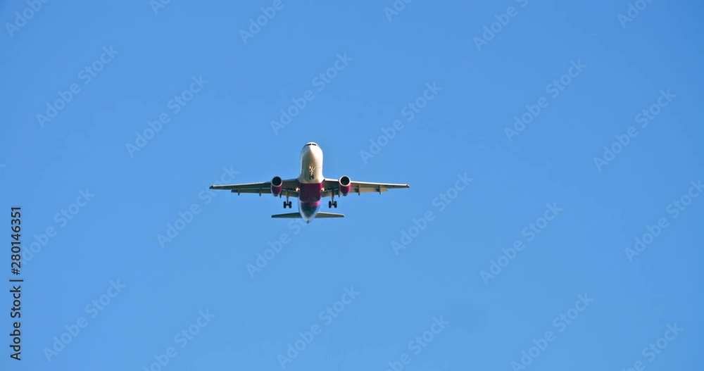 Big commercial aircraft flying in the blue clear sky. Upward view of the soaring airplane. Modern aviation and transportation. Big commercial aircraft flying in the blue clear sky. Upward view of the soaring airplane. Modern aviation and transportation.