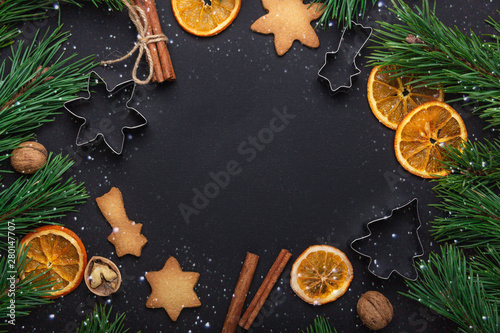 Homemade fresh cookies Fir branches Dried slices of orange Cookie cutters Christmas concept