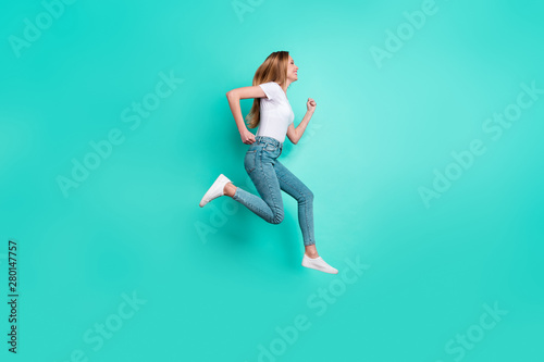Profile side full size photo of nice girl running smiling isolated over teal turquoise background
