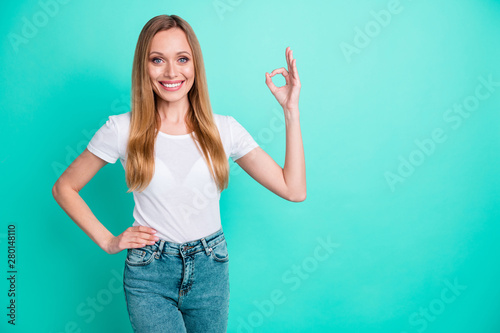 Portrait of lovely charming lady showing ok sign smiling suggesting ads isolated over teal turquoise background