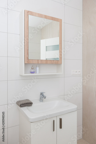 Contemporary bathroom interior with mirror and cabinet