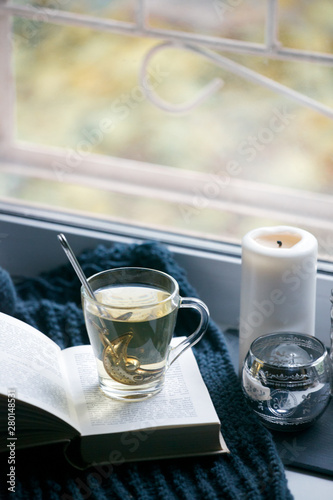 Cosy and soft winter, autumn, fall background, knitted decor and books on an windowsill. Christmas holidays at home, calmness closeup, weekend concept
