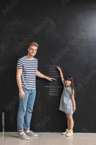Father measuring height of ...