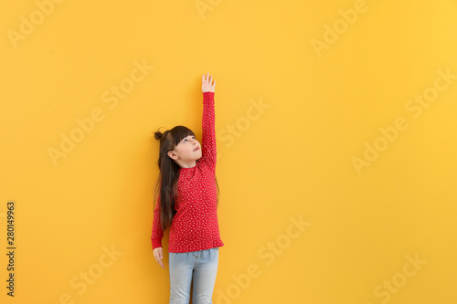 Cute little girl measuring ...