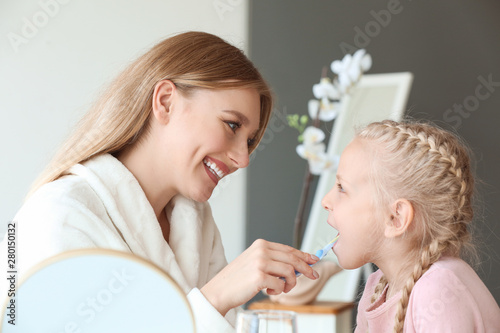 Woman cleaning teeth of her...