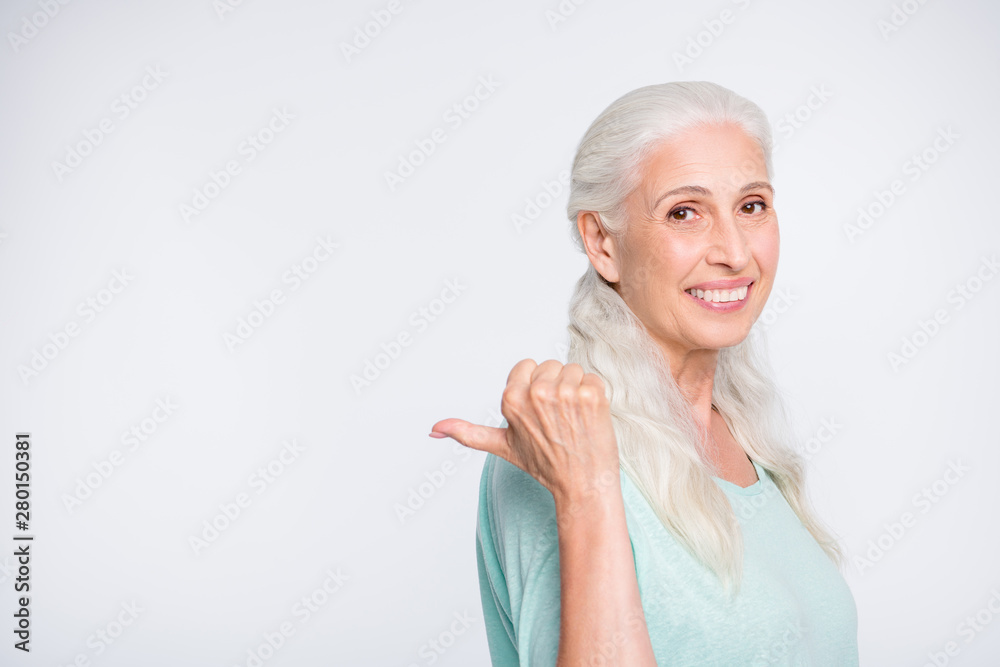 Portrait of charming person showing promotion with her thumb smiling wearing turquoise pullover sweater isolated over white background Portrait of charming person showing promotion with her thumb smiling wearing turquoise pullover sweater isolated over white background