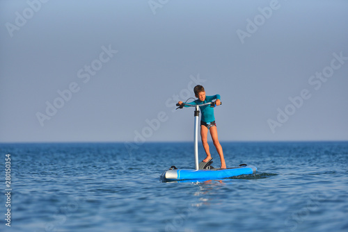 Happy active kid on a Hobie Stand Up Paddle board