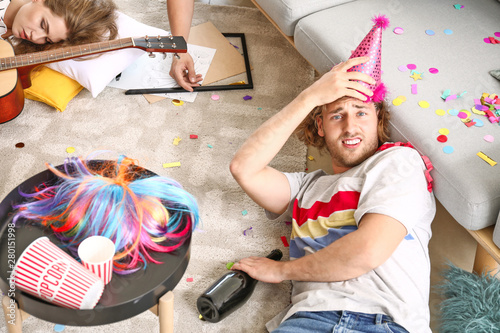 Canvas Print Young man with hangover after party at home
