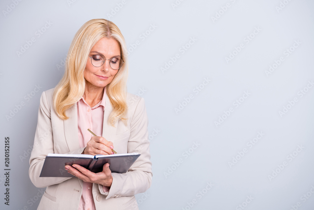Portrait of her she nice-looking attractive lovely stylish peaceful concentrated focused gray-haired lady making notes agenda to-do list isolated over light white gray background Portrait of her she nice-looking attractive lovely stylish peaceful concentrated focused gray-haired lady making notes agenda to-do list isolated over light white gray background