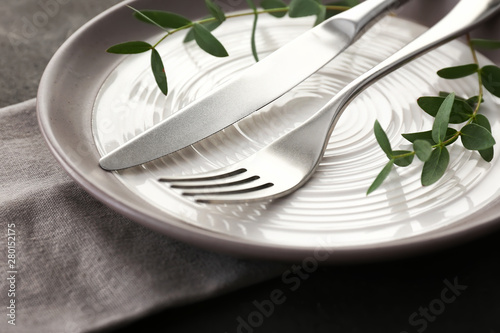 Beautiful table setting on grey background  closeup