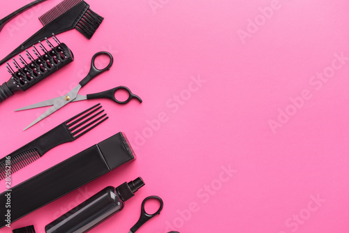 Set of hairdresser tools and accessories on color background