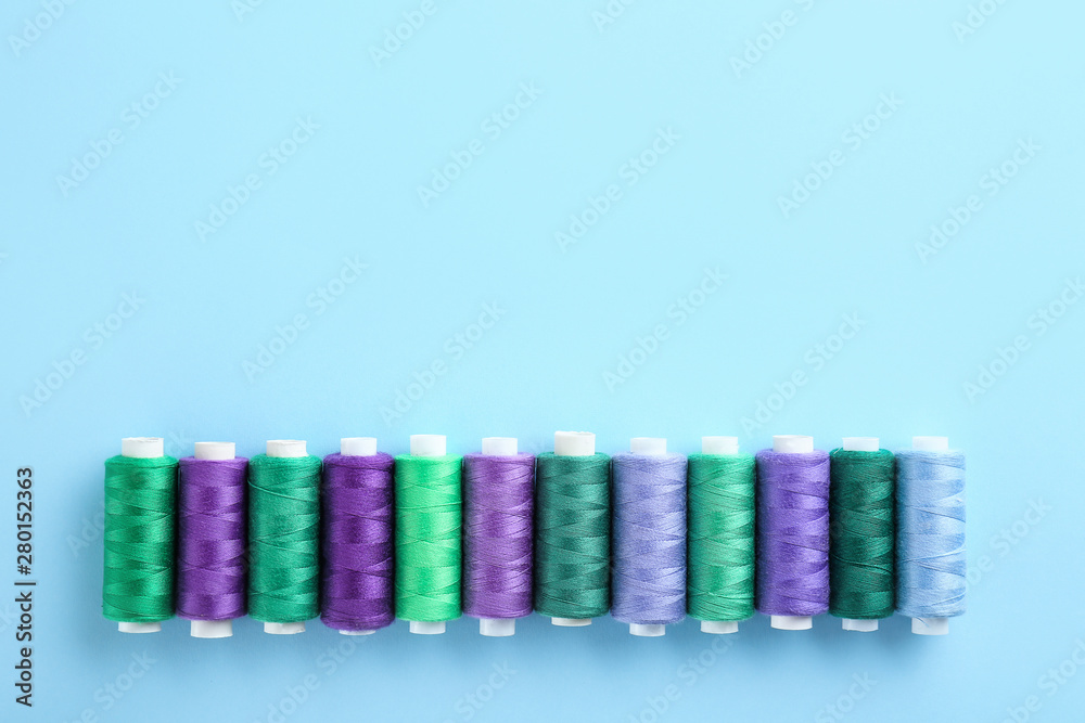 Many sewing threads on color background Many sewing threads on color background