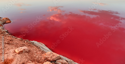 .Incredible Sunset with Sky Reflection over Salty Lake Maharlu in Iran, Fars Province near Shiraz city, with incredibly rich red water like blood photo