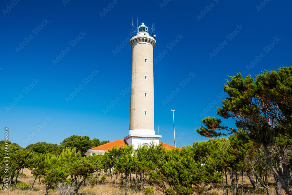 Croatia, island of Dugi Otok, beautiful old lighthouse of Veli Rat on the stone shore among the pines Croatia, island of Dugi Otok, beautiful old lighthouse of Veli Rat on the stone shore among the pines